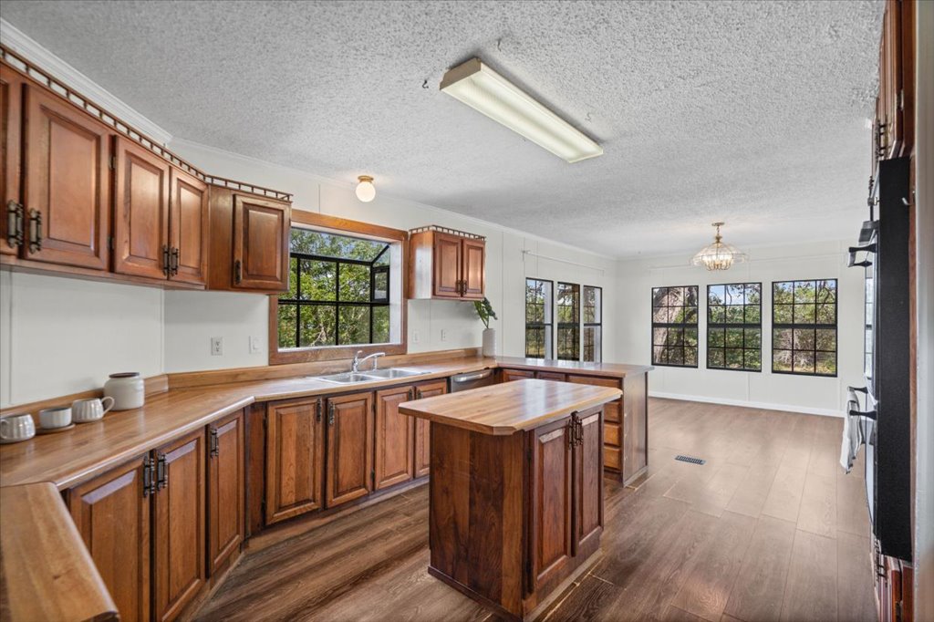 13501 Nutty Brown Road, Unit B Austin, TX 78737 - Photo 12 of 29 Custom cabinetry and generous counter space define this warm, inviting kitchen, perfect for culinary endeavors.