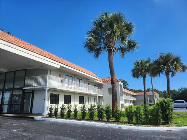 a front view of a house with tree s