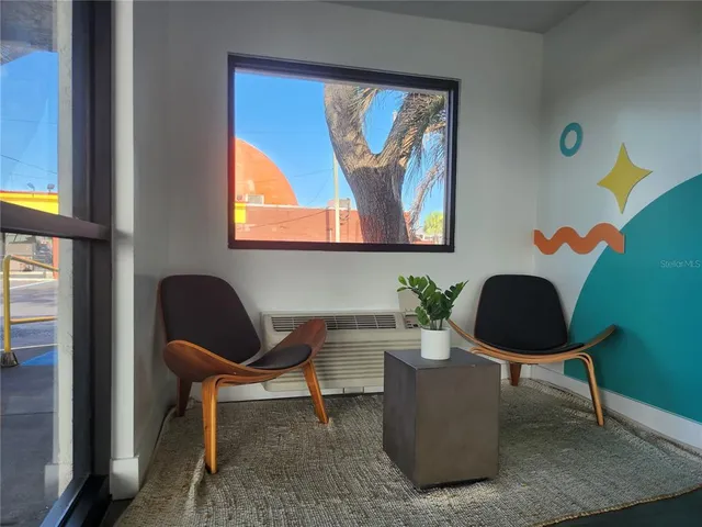 a bedroom with a bed and painting on the wall