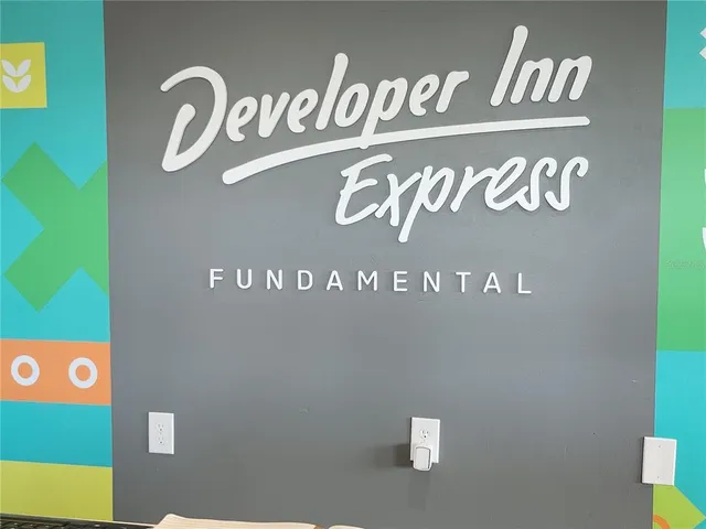 a room with pool table and wall paintings