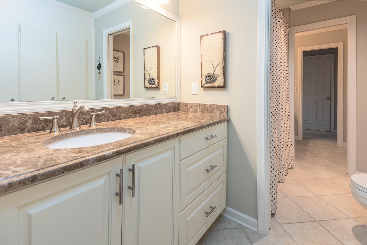 4795 Walnut Grove Road Memphis, TN 38117 - Photo 30 of 40 a bathroom with a granite countertop sink and a mirror