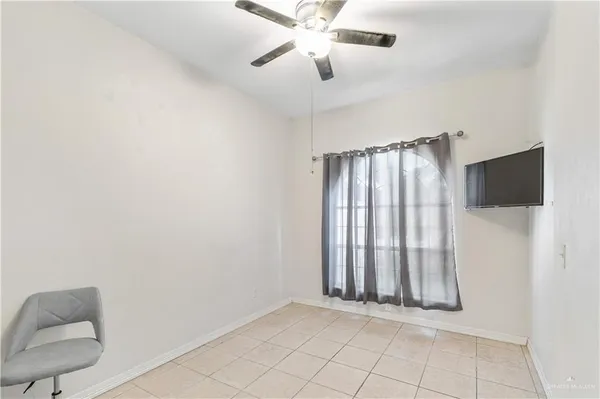 a view of a room with entryway fan and windows