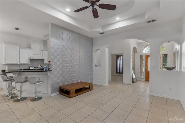 a living room with stainless steel appliances kitchen island granite countertop furniture and a view of living room