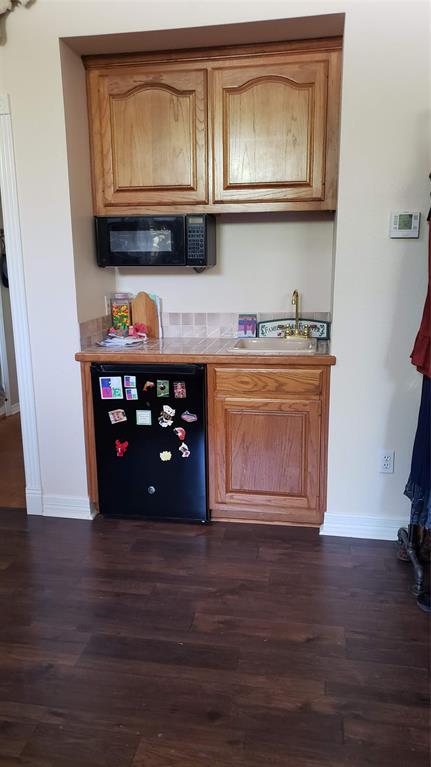 1440 South Keller Road Mineral Wells, TX 76067 - Photo 16 of 24 a kitchen with stainless steel appliances granite countertop a stove and a microwave