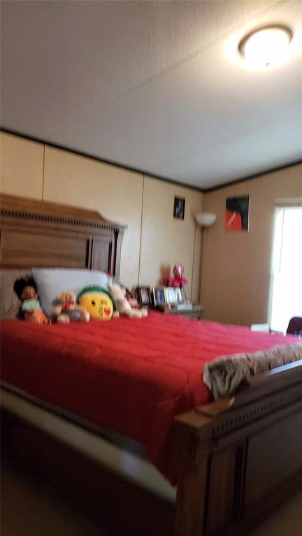 1440 South Keller Road Mineral Wells, TX 76067 - Photo 18 of 24 a bedroom with a bed and dresser