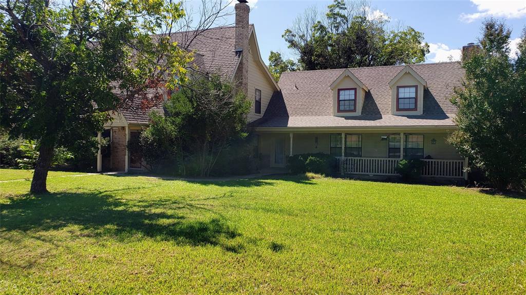 1440 South Keller Road Mineral Wells, TX 76067 - Photo 2 of 24 a view of an house with backyard and trees