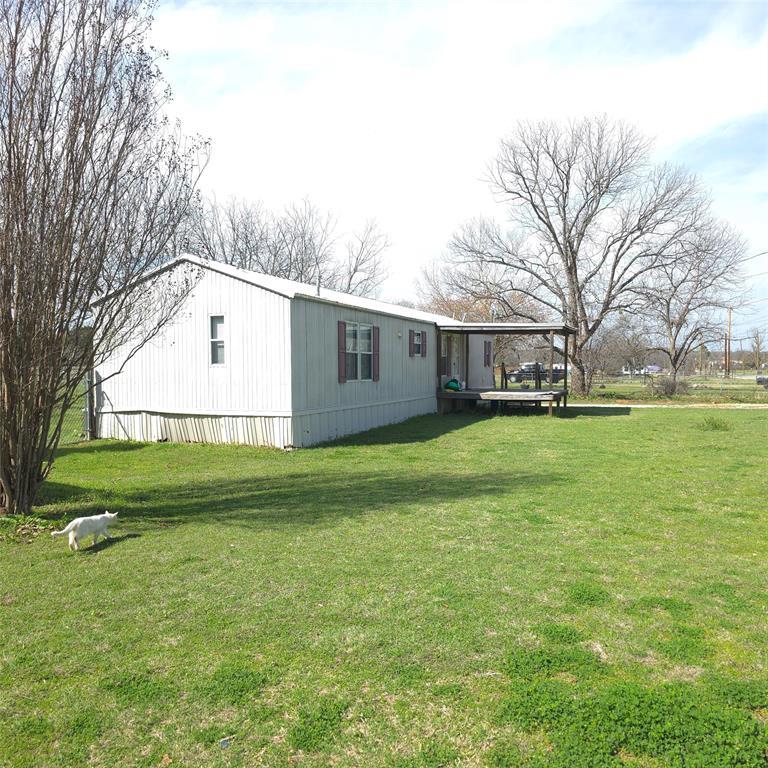 1440 South Keller Road Mineral Wells, TX 76067 - Photo 23 of 24 a view of a white house with a yard