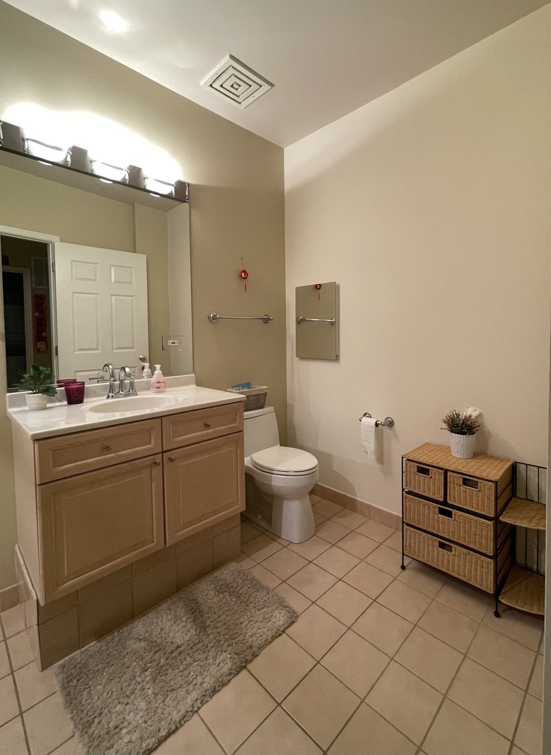 Undisclosed Address Chicago, IL 60604 - Photo 13 of 14 a spacious bathroom with a double vanity sink mirror and toilet