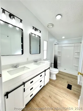 a bathroom with a double vanity sink and mirror