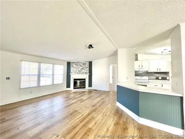 a view of a kitchen with a sink and a fireplace