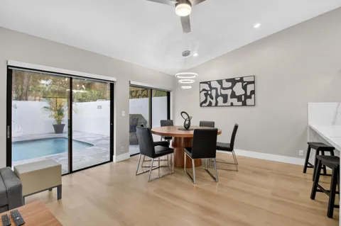 a view of a dining room with furniture and wooden floor