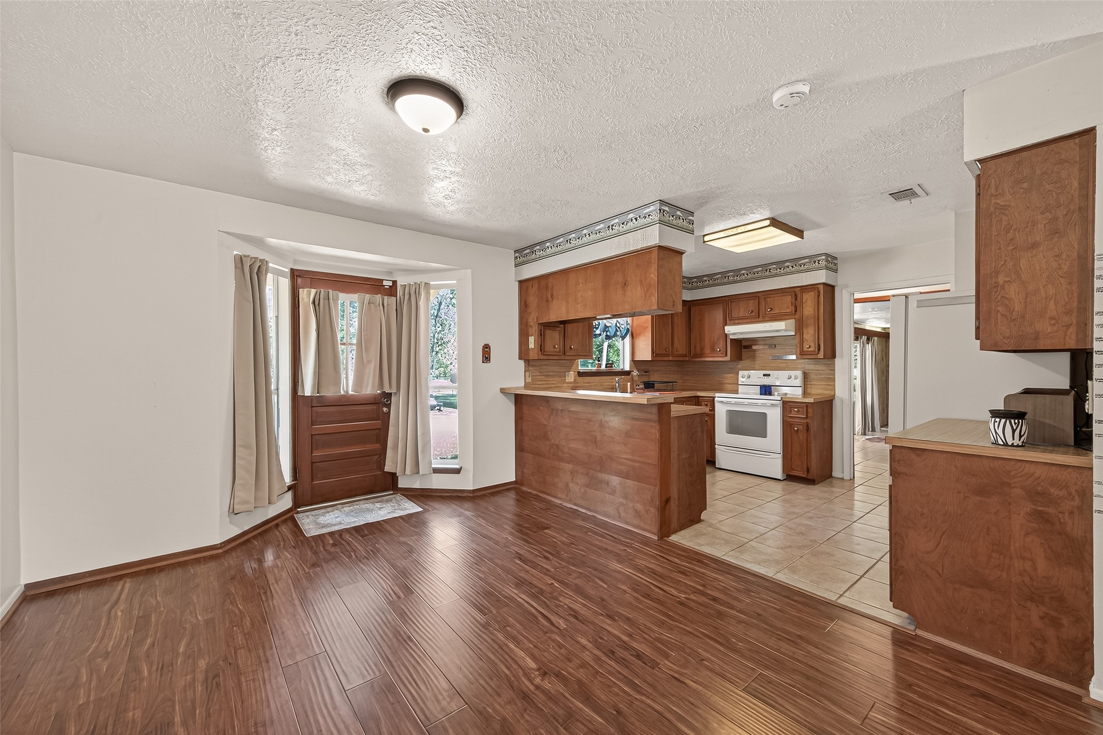11535 Willis Waukegan Road Conroe, TX 77303 - Photo 16 of 47 a open kitchen with cabinets wooden floor and stainless steel appliances