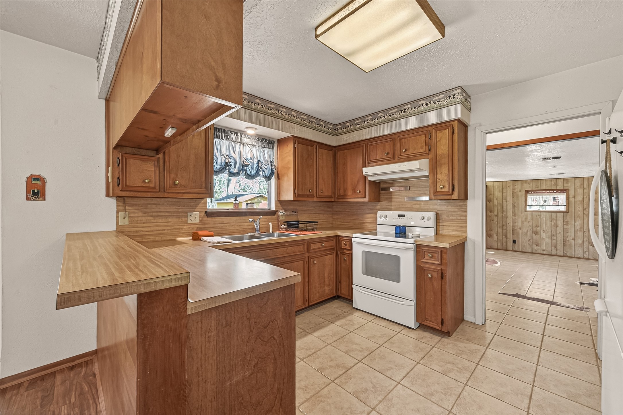 11535 Willis Waukegan Road Conroe, TX 77303 - Photo 18 of 47 a kitchen with a stove sink and cabinets