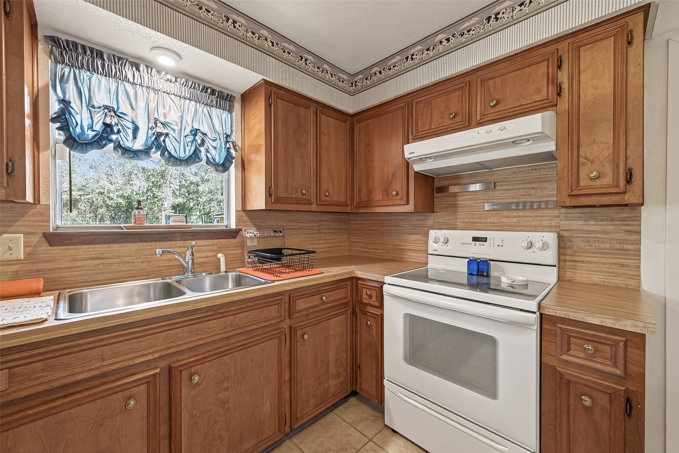 11535 Willis Waukegan Road Conroe, TX 77303 - Photo 22 of 47 a kitchen with a sink stove and cabinets
