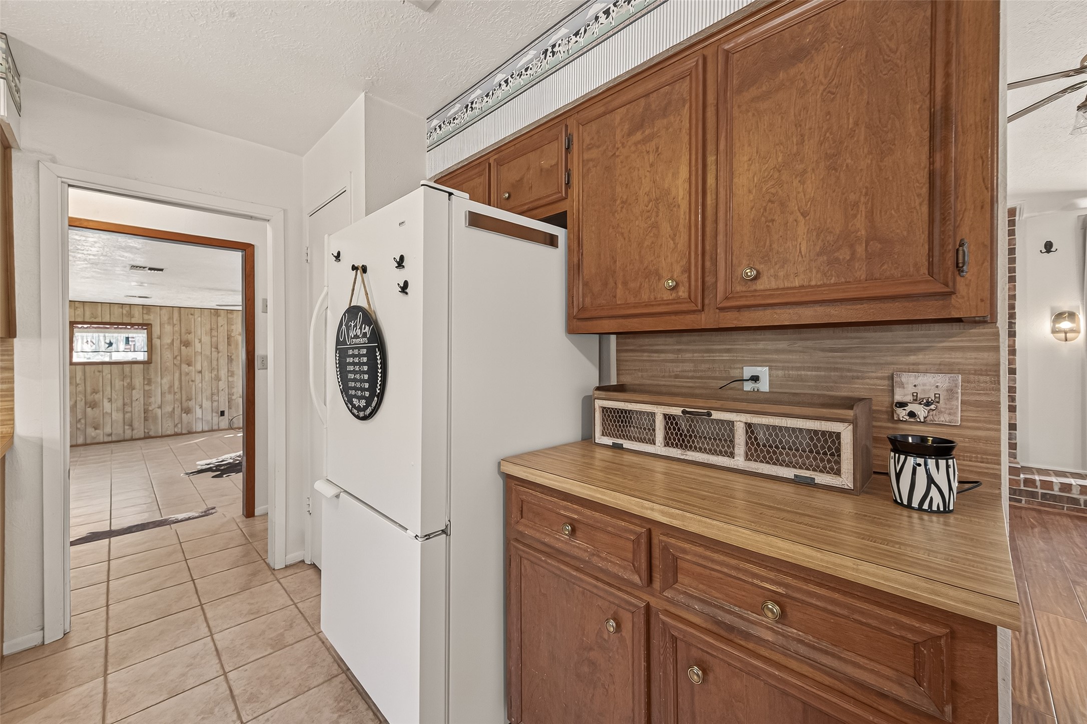 11535 Willis Waukegan Road Conroe, TX 77303 - Photo 23 of 47 a kitchen with a refrigerator and cabinets