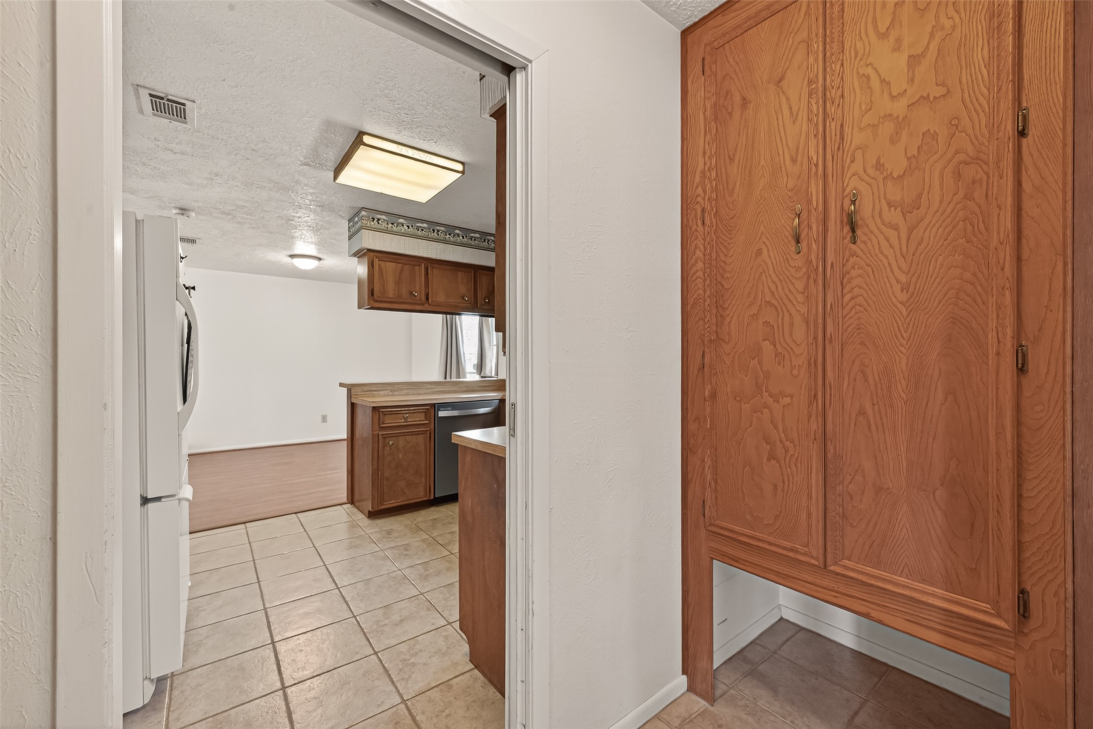 11535 Willis Waukegan Road Conroe, TX 77303 - Photo 24 of 47 a kitchen with a refrigerator and cabinets