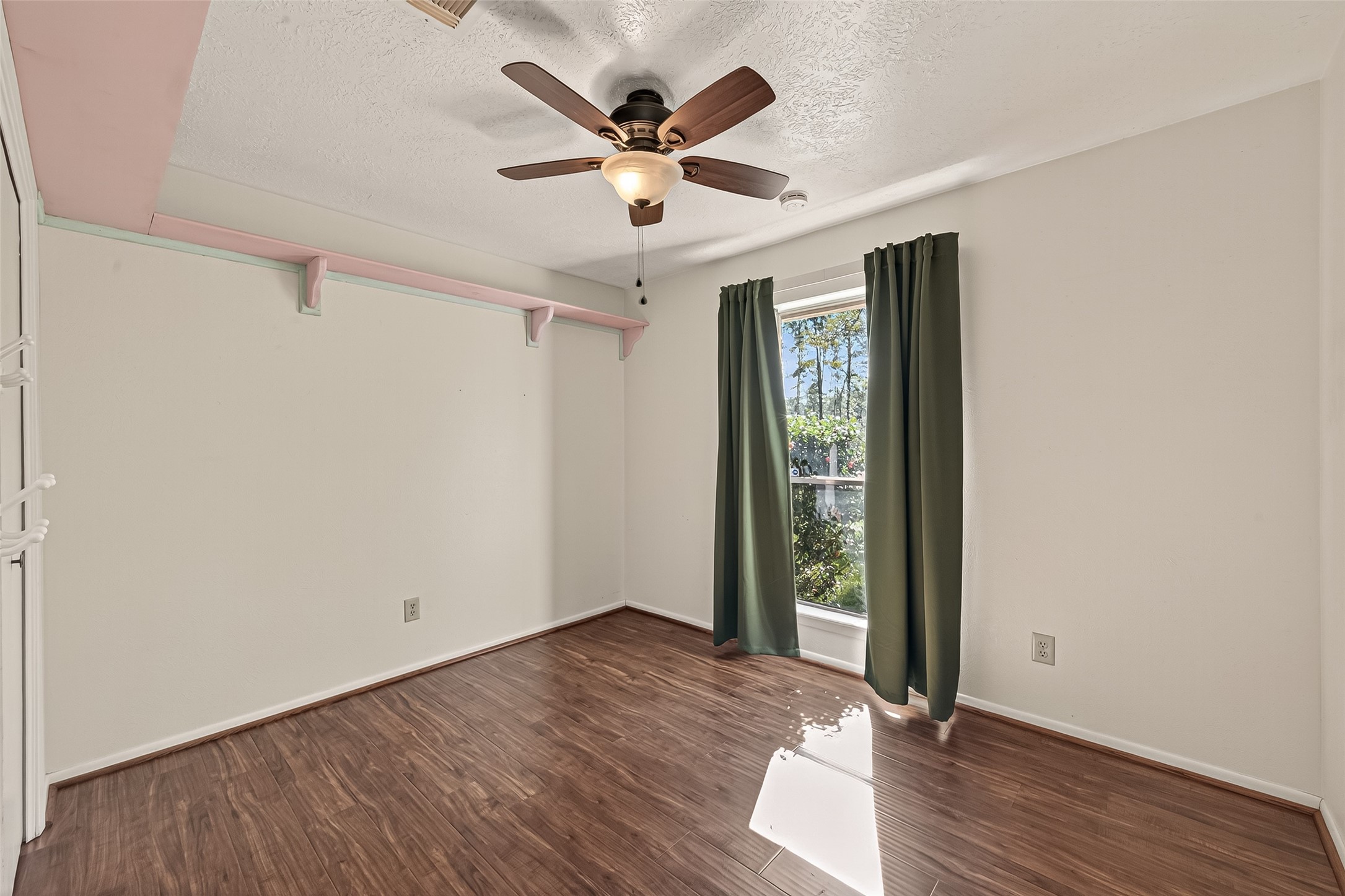 11535 Willis Waukegan Road Conroe, TX 77303 - Photo 27 of 47 wooden floor in an empty room with a window