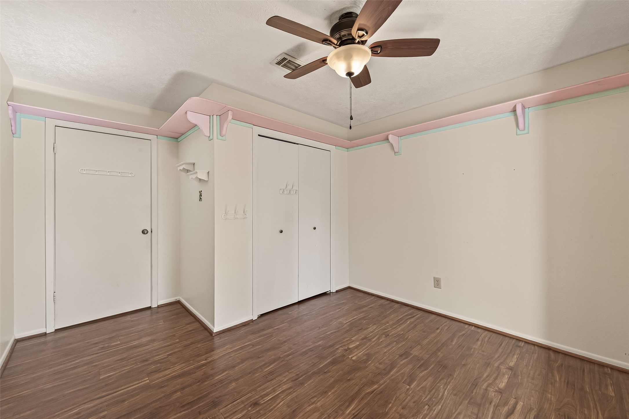 11535 Willis Waukegan Road Conroe, TX 77303 - Photo 28 of 47 an empty room with wooden floor fan and windows