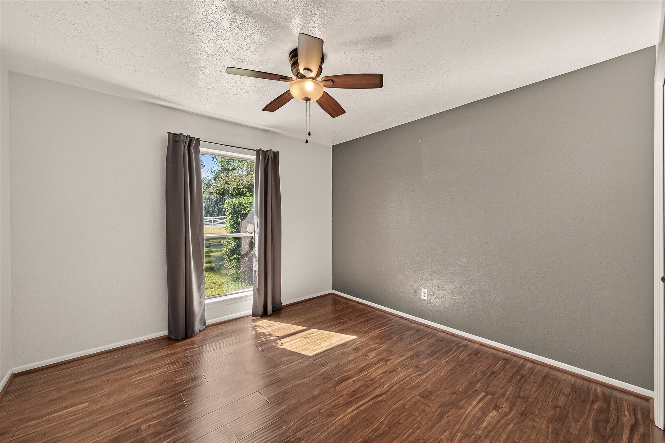 11535 Willis Waukegan Road Conroe, TX 77303 - Photo 30 of 47 an empty room with wooden floor fan and windows