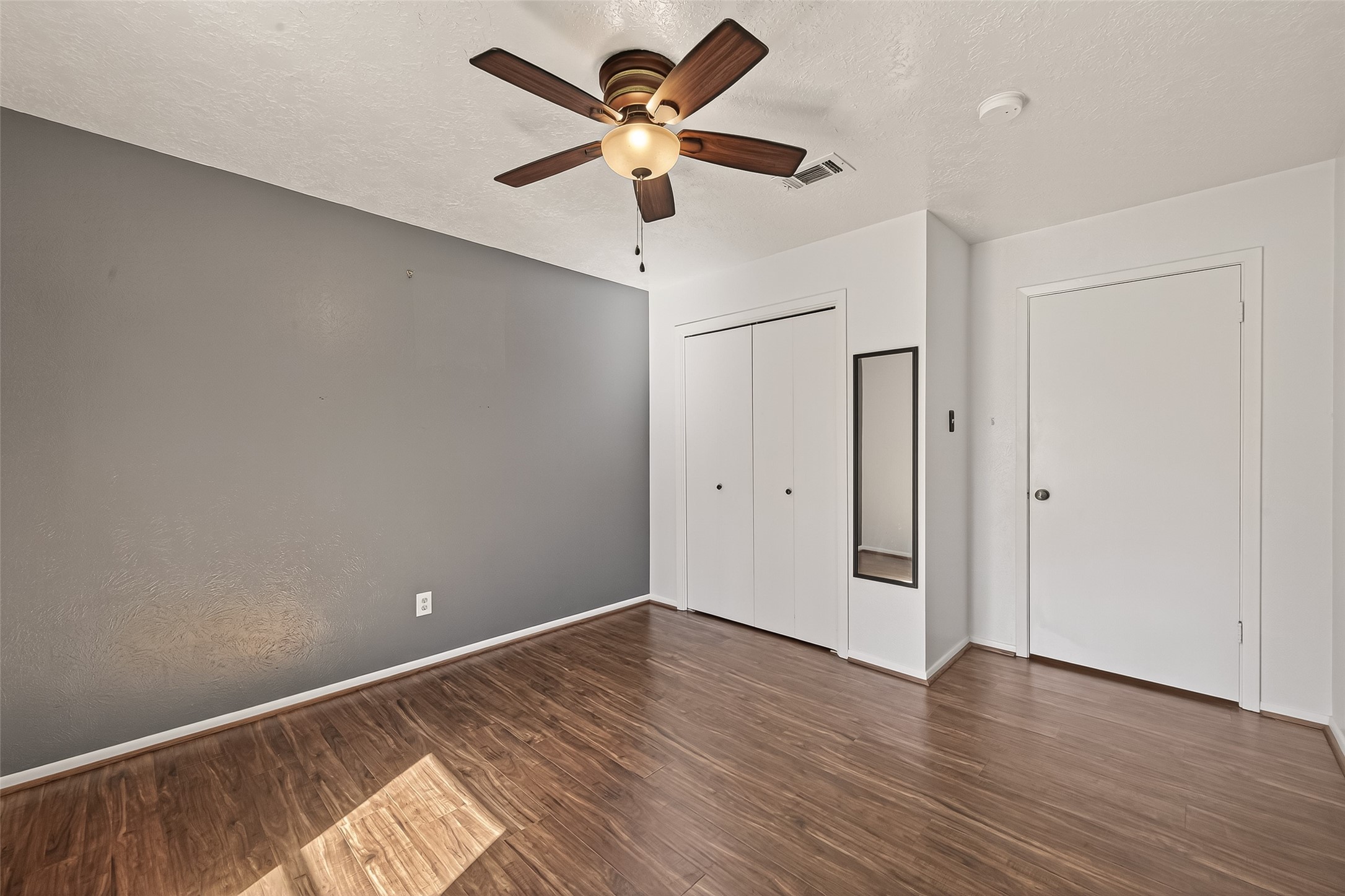 11535 Willis Waukegan Road Conroe, TX 77303 - Photo 31 of 47 a view of room with wooden floor and ceiling fan