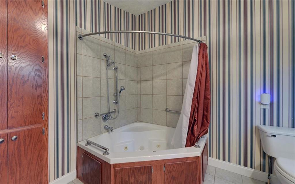 1858 Pinecrest Road Gainesville, GA 30501 - Photo 31 of 55 a bathroom with a tub and shower