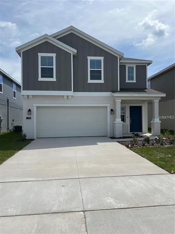 a front view of a house with yard and garage