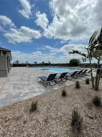 a view of a lake with lawn chairs