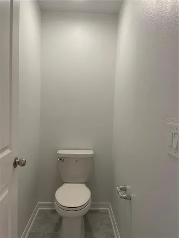 a white toilet sitting in a bathroom