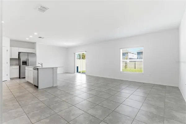 a view of a kitchen with a sink and a refrigerator