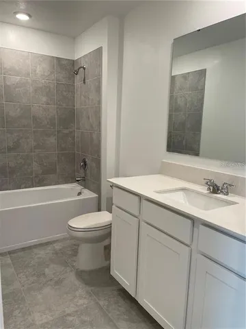 a bathroom with a sink a toilet and bathtub