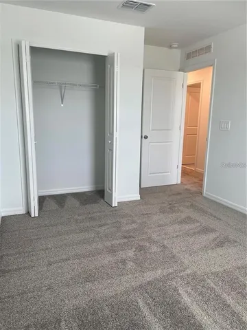 an empty room with closet and closet