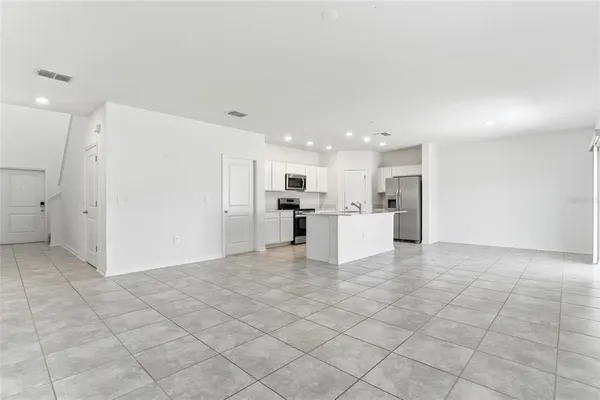 a view of kitchen with furniture and refrigerator