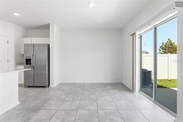 a view of kitchen with granite top and stainless steel appliances