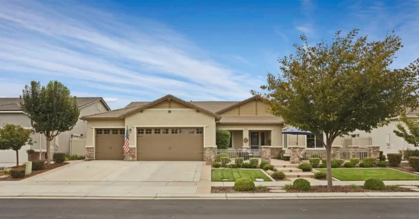 a front view of a house with a garden