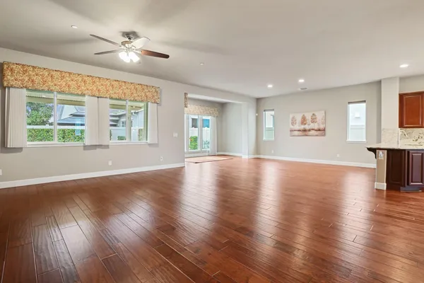 a kitchen with stainless steel appliances granite countertop wooden cabinets a oven and granite counter tops with a large window