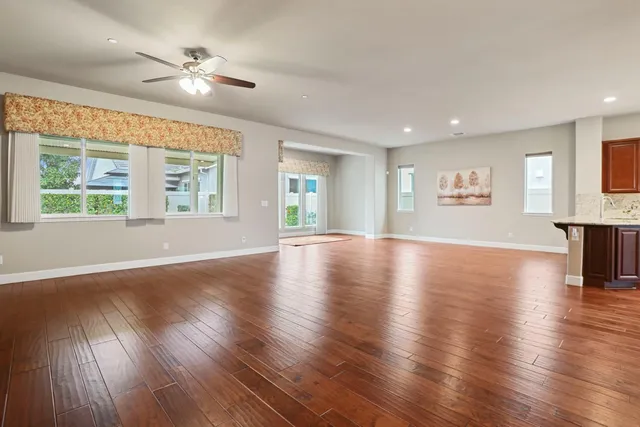 a kitchen with stainless steel appliances granite countertop wooden cabinets a oven and granite counter tops with a large window