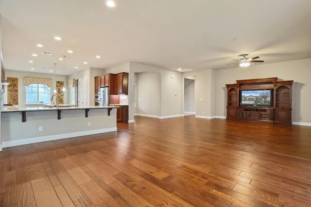 a metallic refrigerator freezer sitting inside of a kitchen