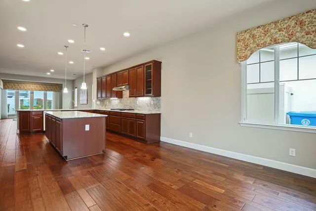 an empty room with a empty space and windows