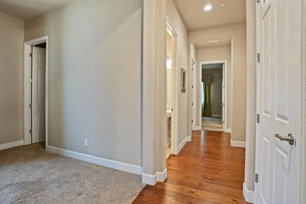 a spacious bathroom with a tub sink and mirror