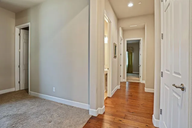 a spacious bathroom with a tub sink and mirror