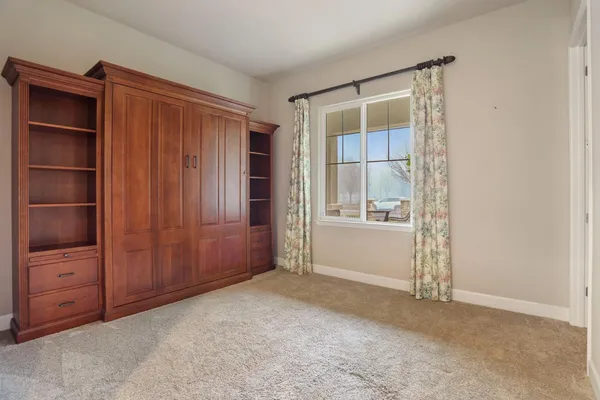 a kitchen with white cabinets and refrigerator