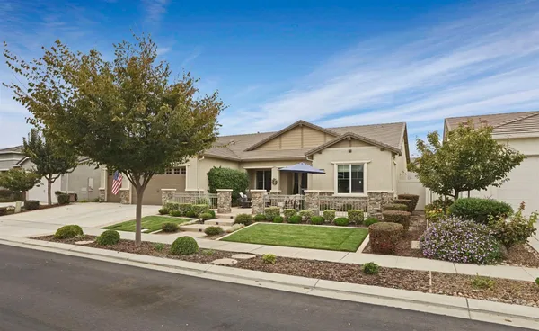 a front view of a house with garden