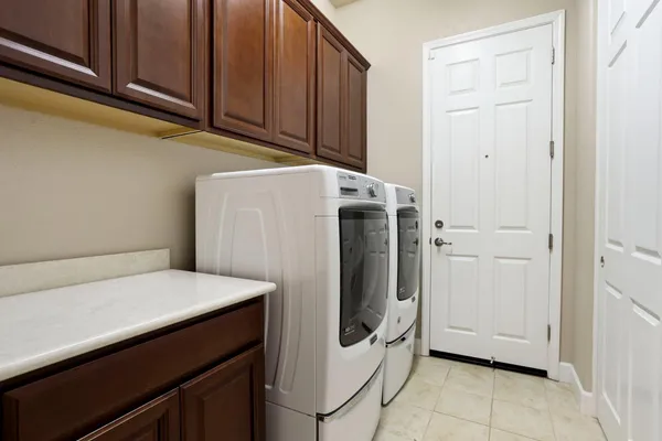 a view of an outdoor dining space with furniture and front door