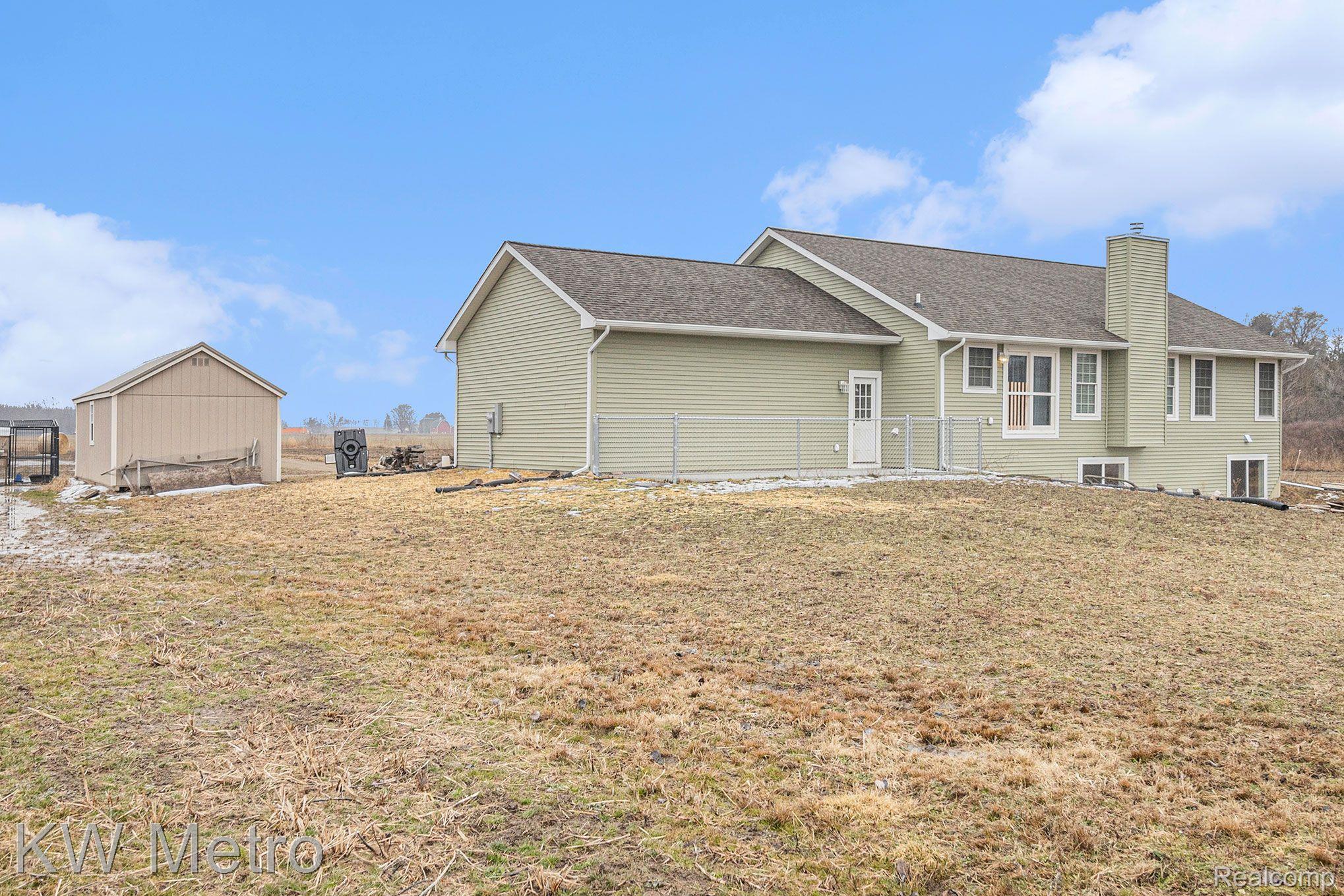 3644 Gannon Road Fowlerville, MI 48836 - Photo 25 of 33 Shed and Rear of House and Fenced Dog Run.