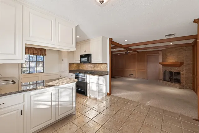 a kitchen with a sink cabinets and appliances