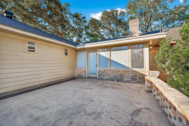 a view of a house with a backyard and a tree