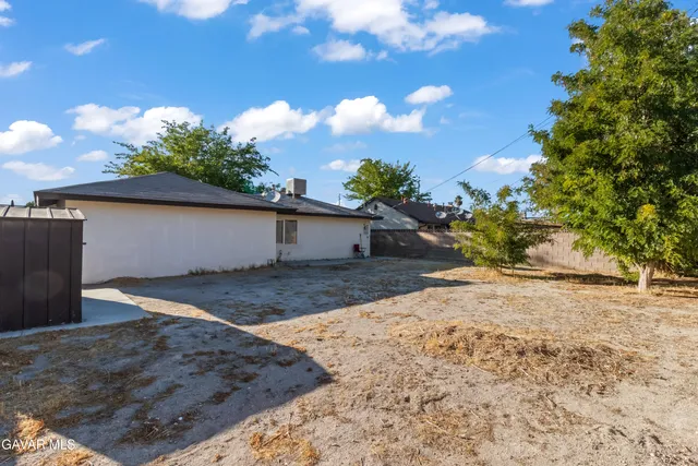 a view of a backyard of the house