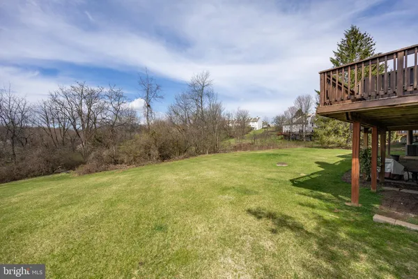 a view of a big yard with furniture and a garden