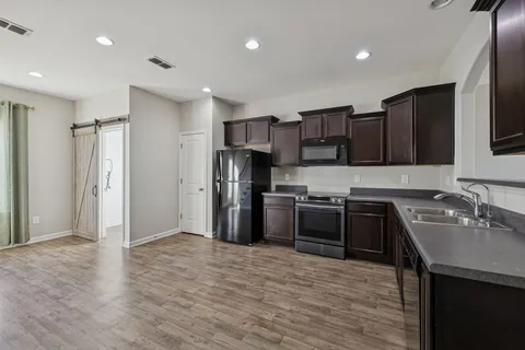 a kitchen with stainless steel appliances granite countertop a sink and a microwave