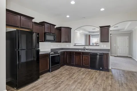 a kitchen with stainless steel appliances granite countertop a sink stove and microwave